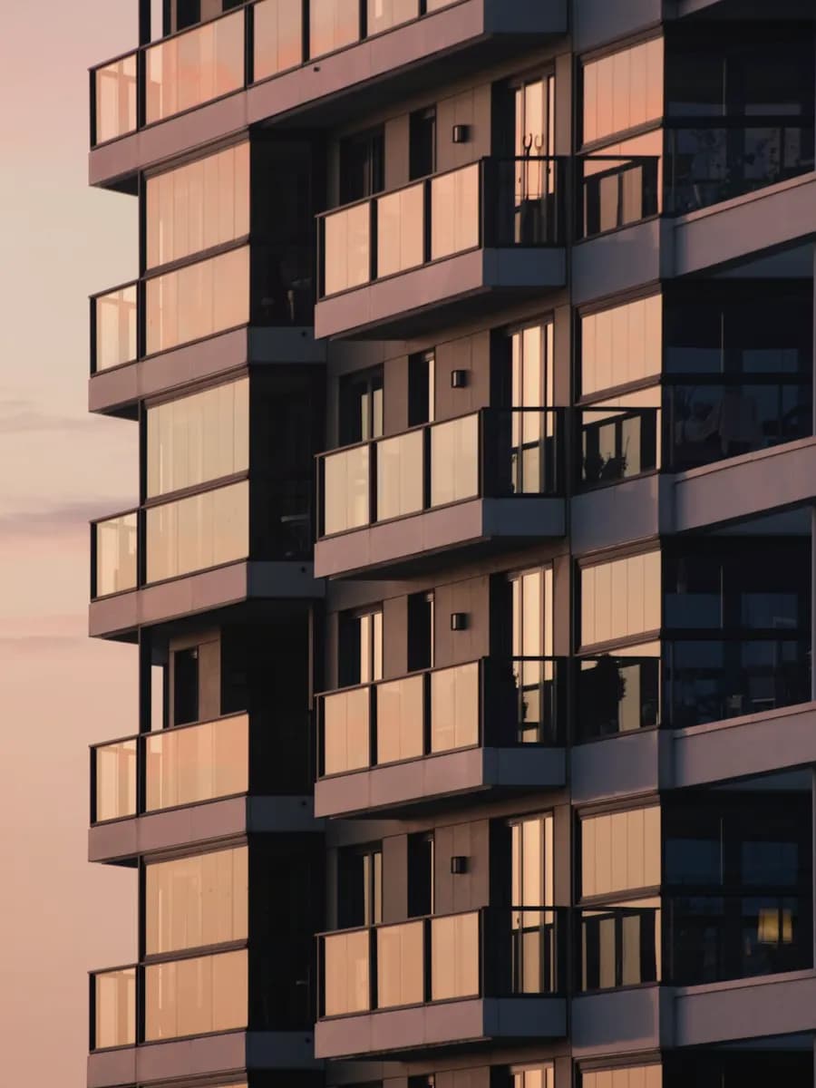 A modern residential tower against an evening sky